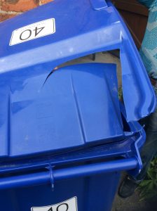 Jane's blue bin with a lid damaged by the collection wagon.