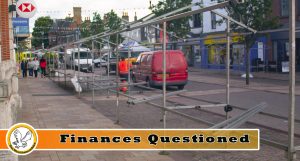 Ormskirk Market being disassembled by a worker in bright orange clothing